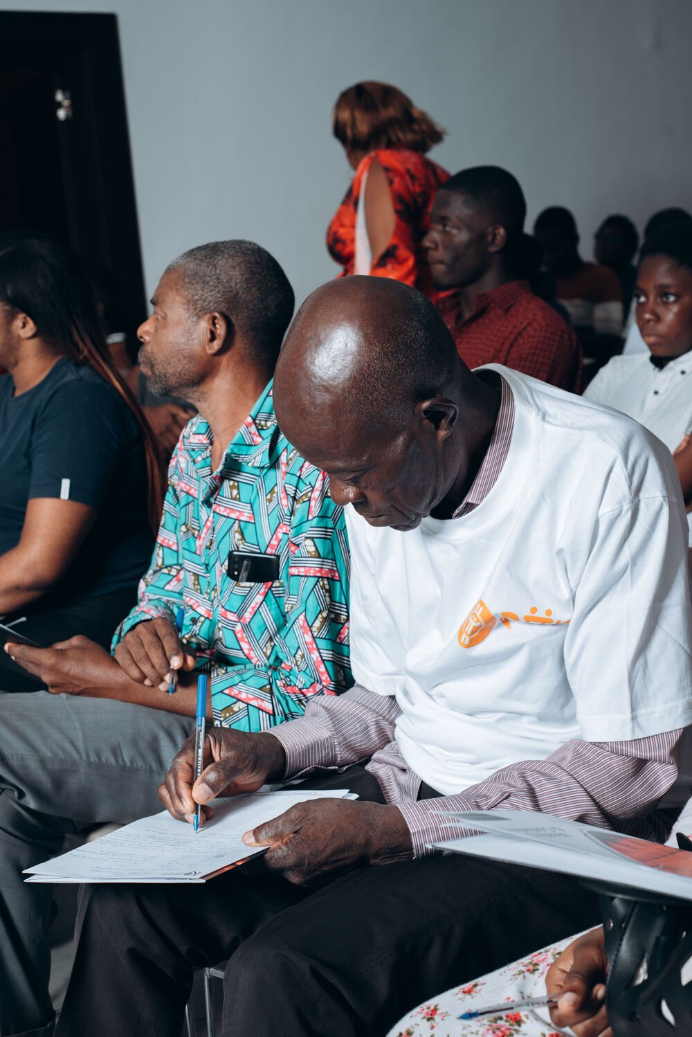An attendee filling in a form during a seminar